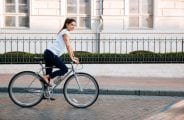 Portrait of a pretty woman on bicycle in the city