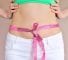 Woman measuring waist with tape on knot, dieting concept.